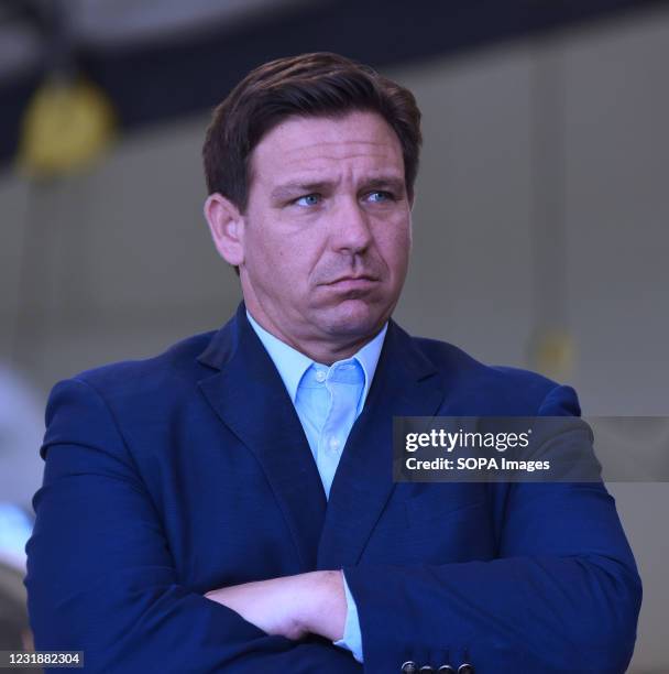 Florida Governor, Ron DeSantis listens to another speaker at a press conference at the Eau Gallie High School aviation hangar. DeSantis announced he...