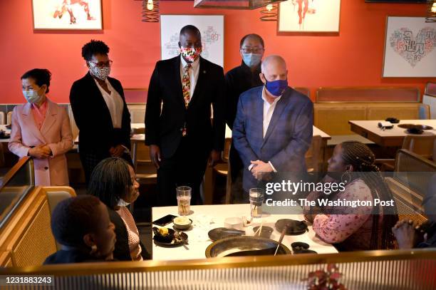 Maryland Gov. Larry Hogan, standing right, along with Howard County Executive Calvin Ball, his wife, Shani Ball, and First Lady Yumi Hogan, talk with...