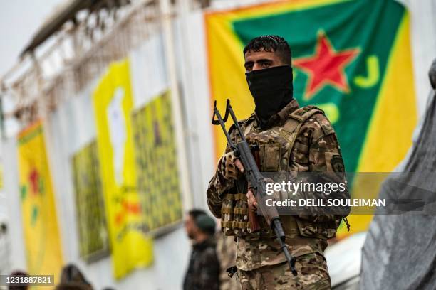 Fighters of the Kurdish-led Syrian Democratic Forces take part in a military parade in the US-protected Al-Omar oil field in the eastern province of...