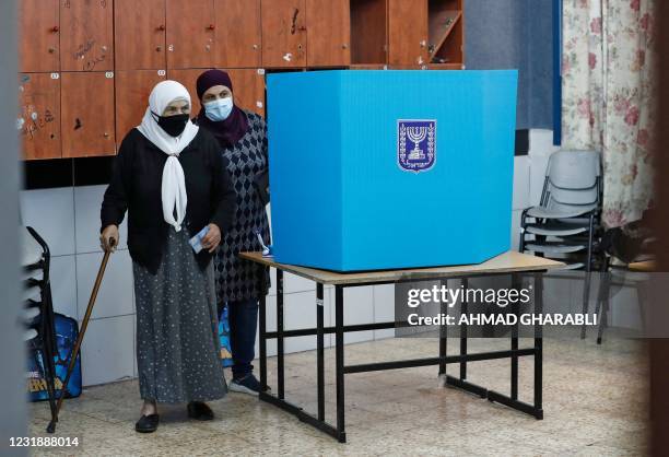 An Arab-Israeli voter, wearing a protective mask against the COVID-19 pandemic, votes on March 23, 2021 in the fourth national election in two years...