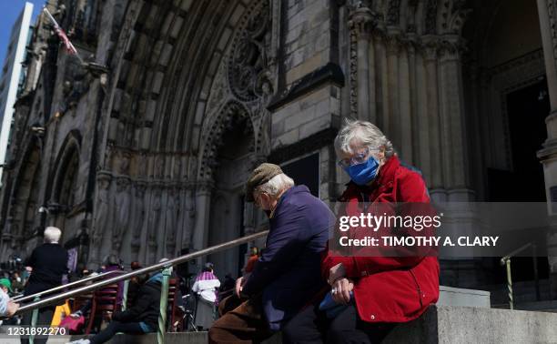 People gather on the steps of Cathedral of St. John the Divine in New York for a Service of Prayer and Witness Against Anti-Asian Violence on March...