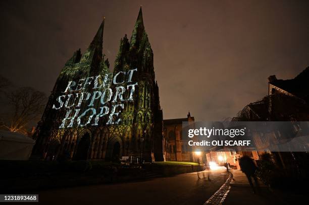 Lichfield Cathedral is illuminated with the words 'Reflect', 'Support', and 'Hope', as part of the National Day of Reflection on the anniversary of...