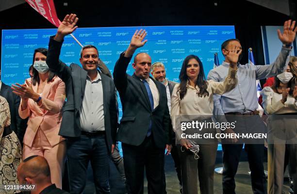 Naftali Bennett , leader of the Israeli right-wing Yamina party, accompanied by party candidate Ayelet Shaked , appears to address supporters at his...