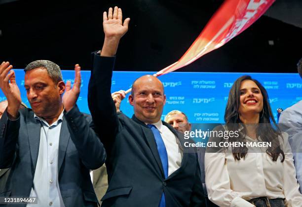 Naftali Bennett , leader of the Israeli right-wing Yamina party, accompanied by party candidate Ayelet Shaked , appears to address supporters at his...