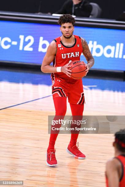 Utah Utes forward Timmy Allen looks to make a pass during the second round game of the men's Pac-12 Tournament between the USC Trojans and the Utah...