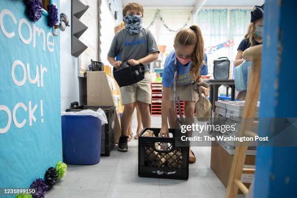 Children retrieve bagged lunches in their classroom at Columbia Elementary School on August 25, 2020 in Columbia, Mississippi. The school is...