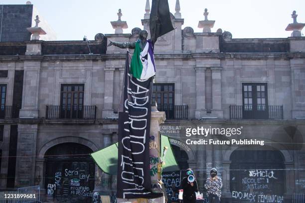 Miguel Hidalgo statue with a feminist flag during a protest of women to demand decriminalization of abortion is State of Mexico. Since March 8,...