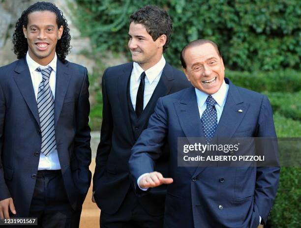Milan's football team's player Ronaldinho and Pato pose with Italian Prime Minister Silvio Berlusconi during a family picture during the visit by...