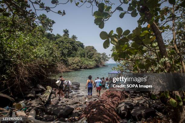 Tourists board a small boat on Sierra Leone's Banana Islands. The Banana Islands were once a slave trading port. They are now home to a few hundred...