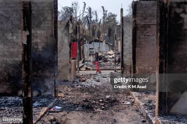 Rohingya refugee girl walking where a massive fire broke out two days ago destroyed thousands of shelters and fifteen people died at Balukhali...