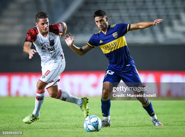 Juan Manuel Olivares of Defensores de Belgrano fights for the ball with Alan Varela of Boca Juniors during a match between Boca Juniors and...