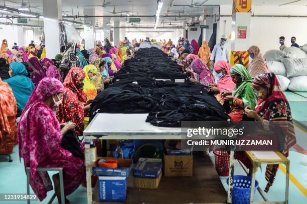 In this picture taken on March 15 women work in a garment factory in Gazipur. - Bangladesh turns 50 this week as an economic success story but an...