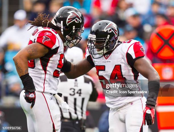 Atlanta Falcons defensive end John Abraham and linebacker Stephen Nicholas celebrate a tackle against the Carolina Panthers during an NFL football...