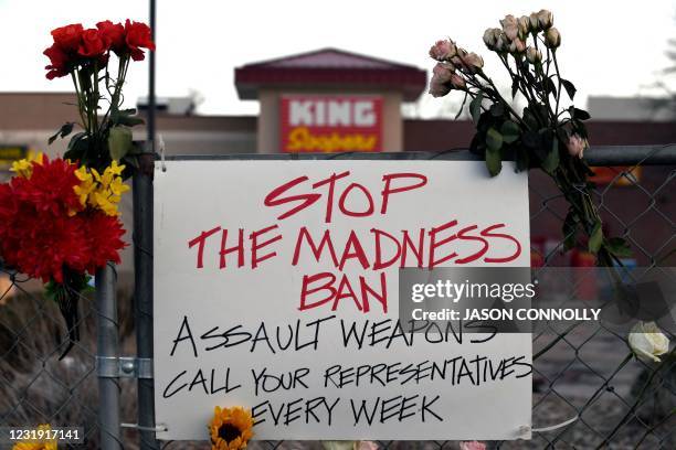 Sign calling for the ban of assault rifles hangs from the perimeter fence outside a King Soopers grocery store in Boulder, Colorado on March 24 to...