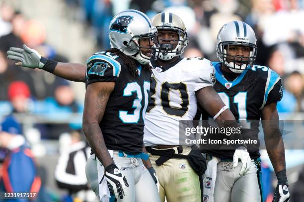 New Orleans Saints running back Lynell Hamilton signals for a first down against Carolina Panthers cornerback Charles Godfrey and cornerback Richard...