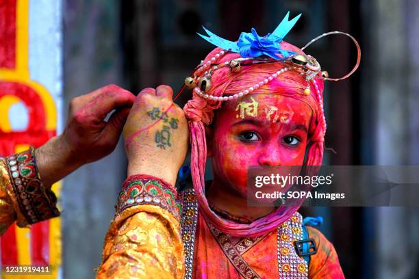 Little boy seen getting ready to take part during the grand Holi celebration at Radharani Tempe of Nandgaon. Holi Festival of India is one of the...