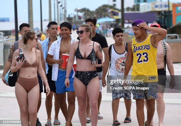 People enjoy themselves while walking along the Daytona Beach boardwalk. As college students arrive in Florida for the annual spring break ritual,...