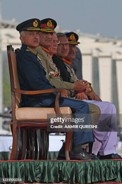 Pakistan's Chief of the Army Staff General Qamar Javed Bajwa and Pakistan's President Arif Alvi watch a military parade to mark Pakistan's National...