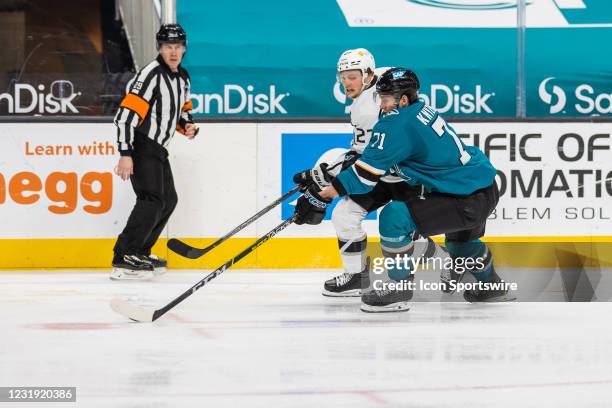 San Jose Sharks Defenceman Nikolai Knyzhov skates with the puck around Los Angeles Kings Left Wing Austin Wagner during the NHL hockey game between...