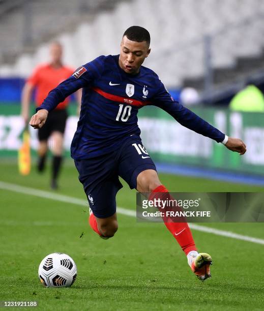France's forward Kylian Mbappe plays the ball during the FIFA World Cup Qatar 2022 qualification football match between France and Ukraine at the...