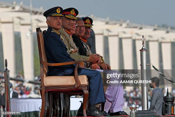 Pakistan's Chief of the Army Staff General Qamar Javed Bajwa and Pakistan's President Arif Alvi watch a military parade to mark Pakistan's National...