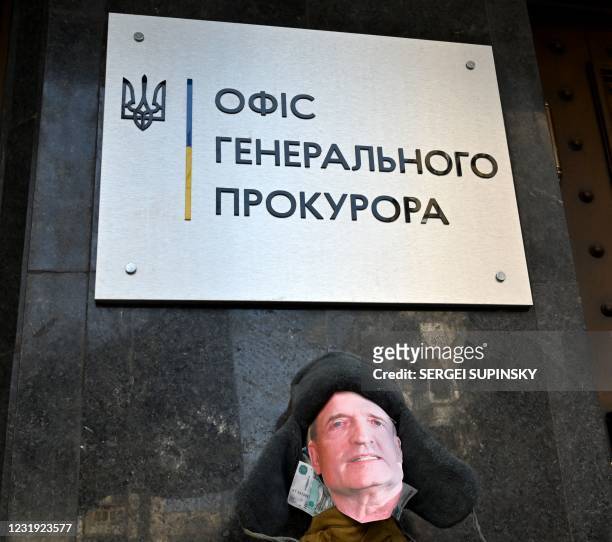 Mannequin symbolizing pro-Russian MP and Putin ally Viktor Medvedchuk in a jacket stuffed with Russian rubles sits outside the Prosecutor General's...
