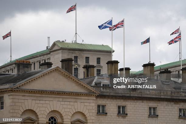 Union Flags flutter at the Ministry of Defence and The Scotland Office on Whitehall, central London on March 25, 2021. - Under new guidance from the...