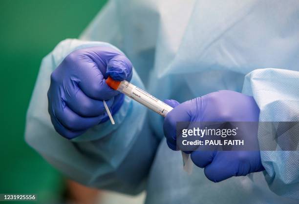 Health worker prepares to administer a swab test for Covid-19 at a walk-in portable testing centre operated by the ambulance service in Dublin,...
