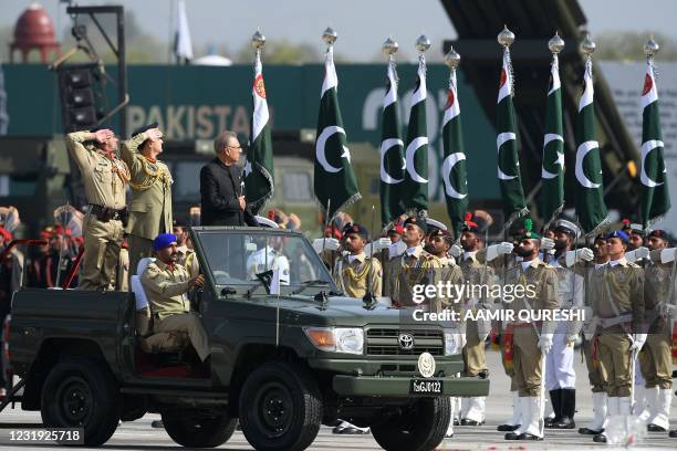 Pakistan's President Arif Alvi inspects the guard of honour during a military parade to mark Pakistan's National Day in Islamabad on March 25, 2021.