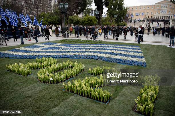People holding Greek flags, went at Syntagma Square to see the decorations of the 200 years since the revolution of March 25 after the Greek...