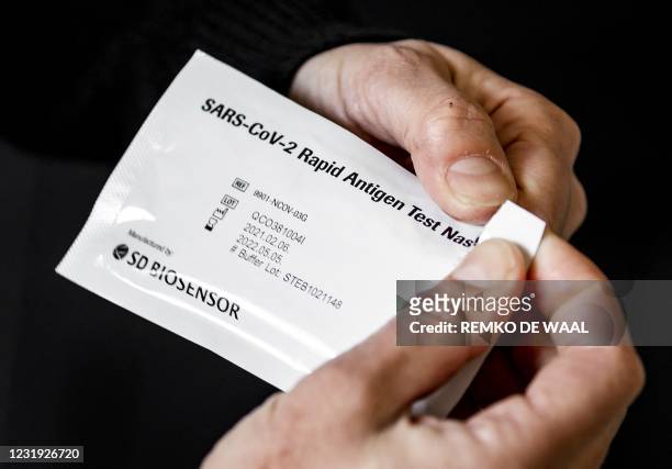 Sachet containing a Covid-19 self test from Roche is displayed in Utrecht on March 25, 2021. - The Ministry of Health has approved two self-tests...