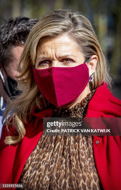 Netherland's Queen Maxima wearing a protective face mask visits an event of non-profit credit organization Qredits in The Hague on March 25 2021. /...