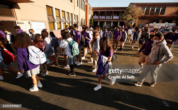 High School students make their way to classrooms as they return to in-person instruction at St. Anthony Catholic High School in Long Beach March 24,...