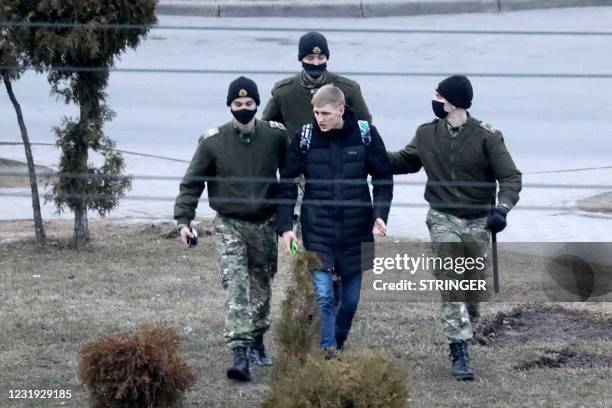 Law enforcement officers detain a man in Minsk, on March 25, 2021. - Scattered groups of protesters in Belarus on March 25 tried to breathe life into...