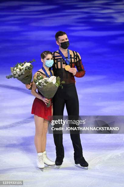 Russia's Anastasia Mishina and Aleksandr Galliamov celebrate winning gold in the pairs' free skating programme event at the ISU World Figure Skating...