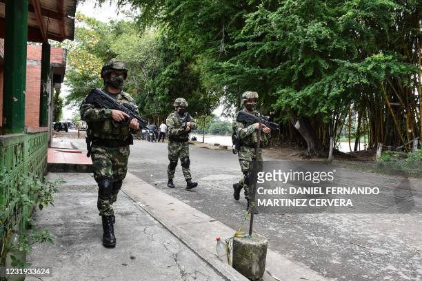 Colombian soldiers patrol near the Arauca river in Arauquita municipality, Arauca department, Colombia on March 25 , 2021. - More than 3,000 people...