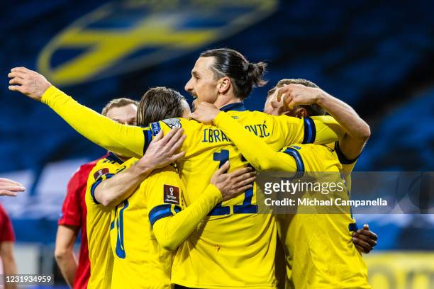 Zlatan Ibrahimovic of Sweden and teammates embrace after Viktor Claesson scored their first goal during the FIFA World Cup 2022 Qatar qualifying...