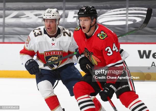 Carter Verhaeghe of the Florida Panthers and Carl Soderberg of the Chicago Blackhawks battle for position in the first period at the United Center on...