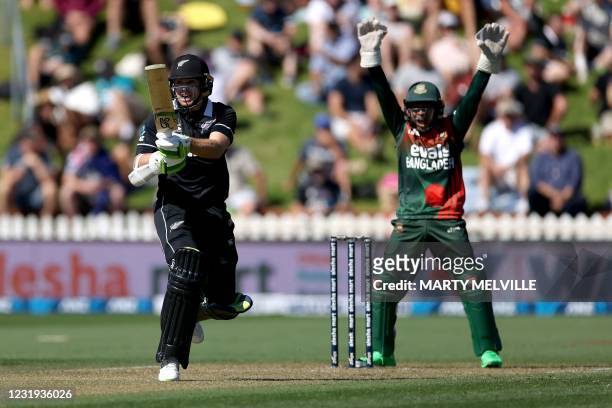 New Zealand's captain Tom Latham plays a shot as Bangladesh's wicketkeeper Mustafizur Rahman appeals for a leg before wicket call during the third...