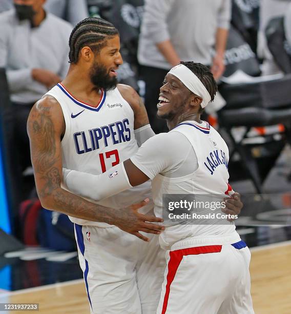 Reggie Jackson of the Los Angeles Clippers celebrates with teammate Paul George after defeating the San Antonio Spurs at AT&T Center on March 25,...