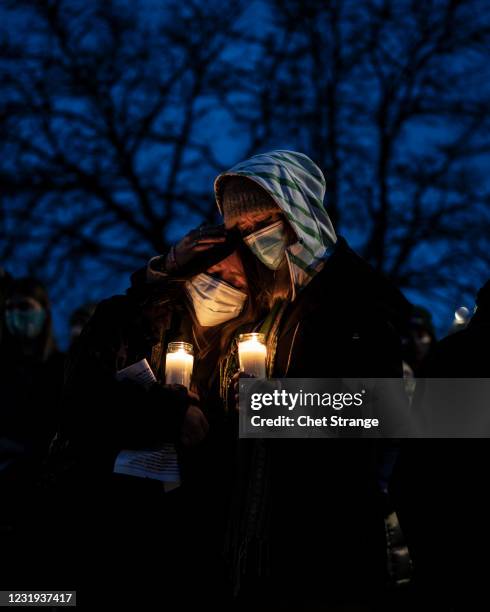 Mourners attend a vigil to commemorate the victims of a mass shooting at a King Soopers grocery store on Thursday, March 25, 2021 in Boulder,...