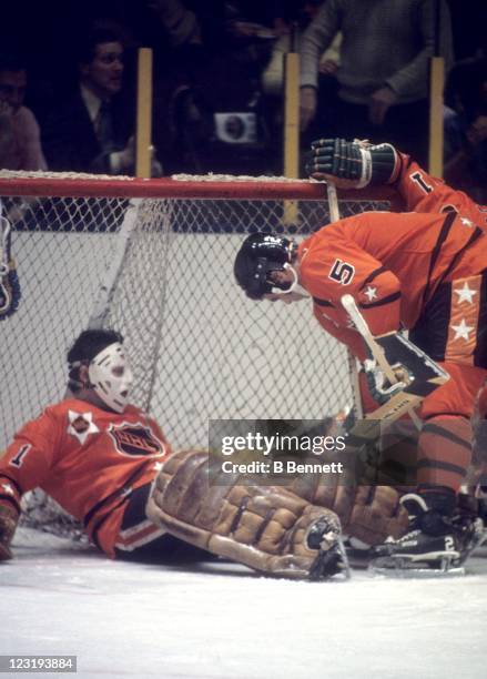 Goalie Tony Esposito of the Chicago Blackhawks and Barry Gibbs of the Minnesota North Stars both from Team West defend the net during the 26th NHL...