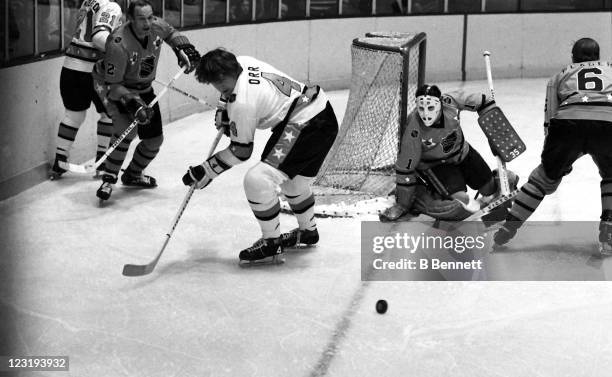 Bobby Orr of the Boston Bruins and Team East looks to control the puck as goalie Tony Esposito of the Chicago Blackhawks and Team West defends the...