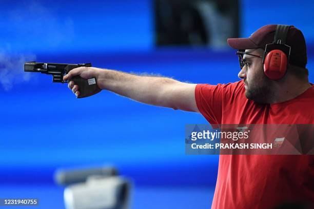 Bronze medalist Oskar Miliwek of Poland competes in 25m Rapid Fire Pistol men Final event of ISSF World Cup 2021 at Karni Singh Shooting Range in New...