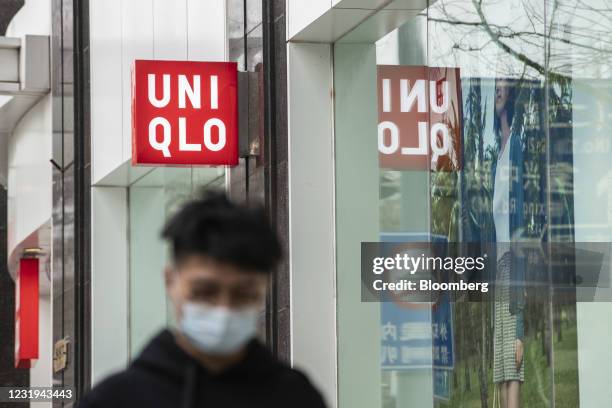 Uniqlo sign hangs above the entrance to a Uniqlo store, operated by Fast Retailing Co., in Shanghai, China, on Friday, March 26, 2021. Japanese...