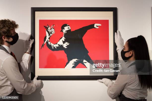 Love is in the Air by Banksy is displayed during preparations ahead of online sales at Christies Auction House on March 26, 2021 in London, England....