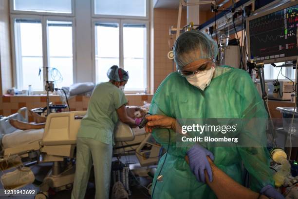 Healthcare workers comfort Covid-19 patients in the ICU ward at the General University Hospital in Prague, Czech Republic, on Friday, March 26, 2021....