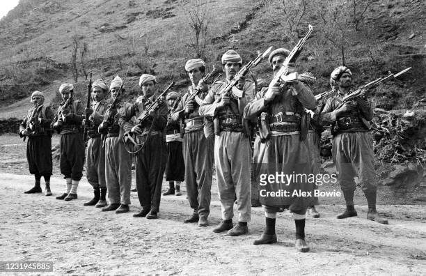 Kurdish Peshmerga fighters parade with Kalashnikov AK-47 assault rifles at a hidden military camp in the Zagros Mountains of northern Iraq, 10th May...