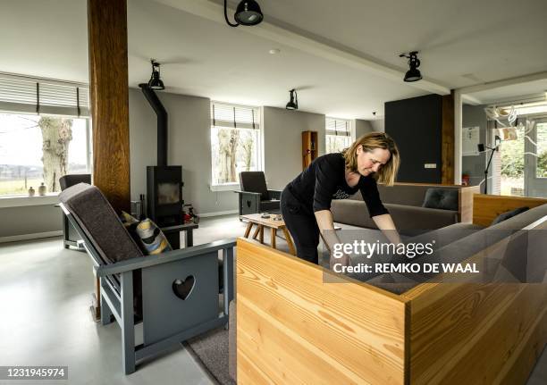 Woman cleans and arranges a holiday home owned by Staatsbosbeheer in Apeldoorn on March 26, 2021. - Dutch nationals are booking more holidays within...