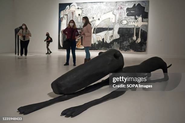 People chat as a large painting and sculpture are seen displayed during the opening of the exhibition at Contemporary Art Center. Spanish artist...